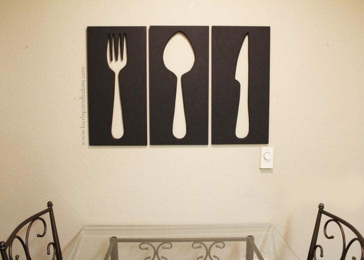 Large wall art of fork, spoon, and knife wood cutouts image.