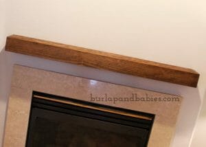 DIY wooden box placed on wall above fireplace image.