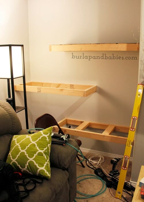 DIY unfinished wooden shelves attached to a wall image.