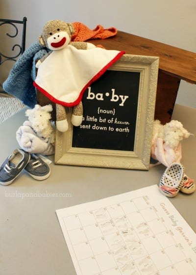 Display of framed baby quote, baby shoes and stuffed monkey image.