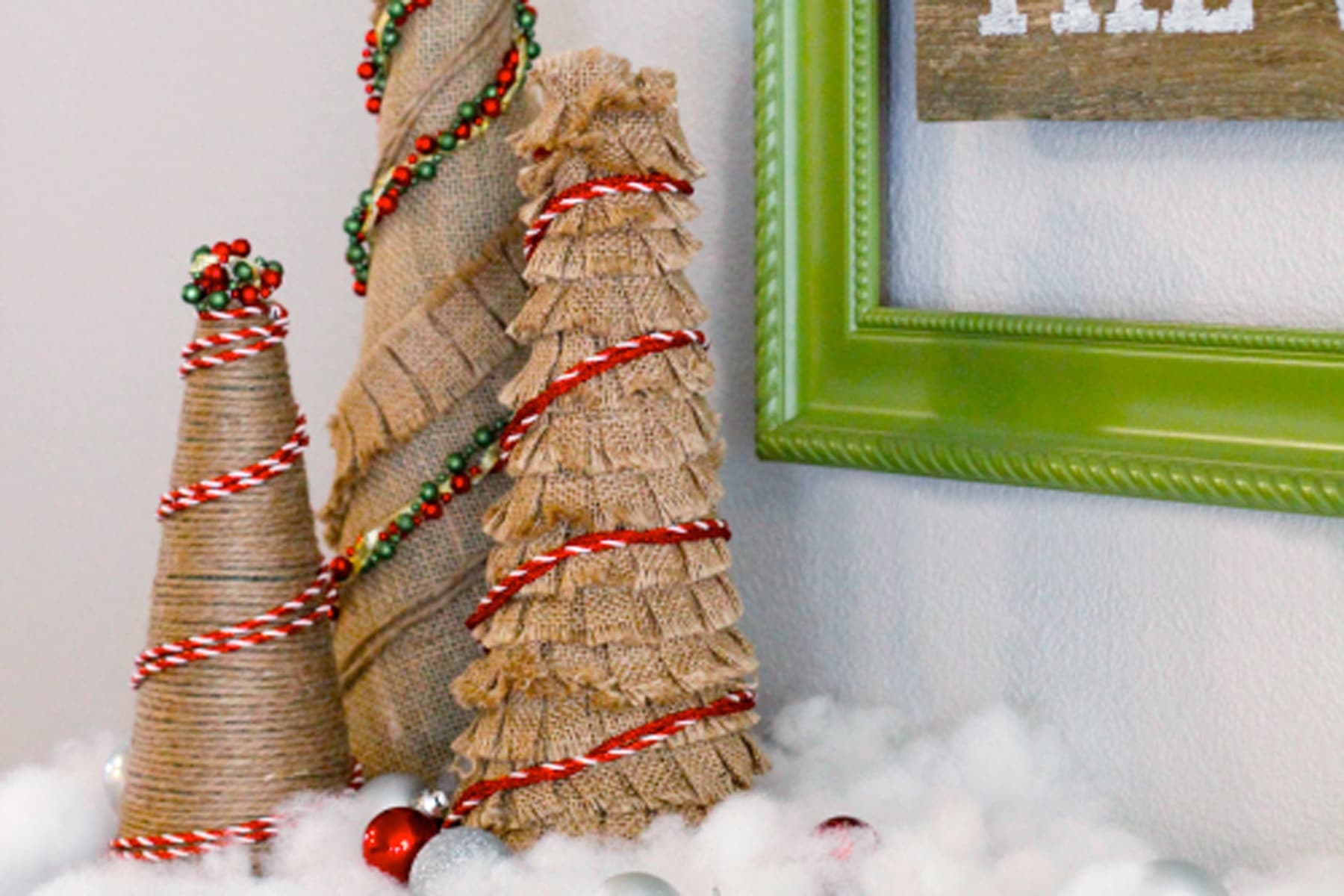 Mini burlap christmas trees with red trim against a green frame image.