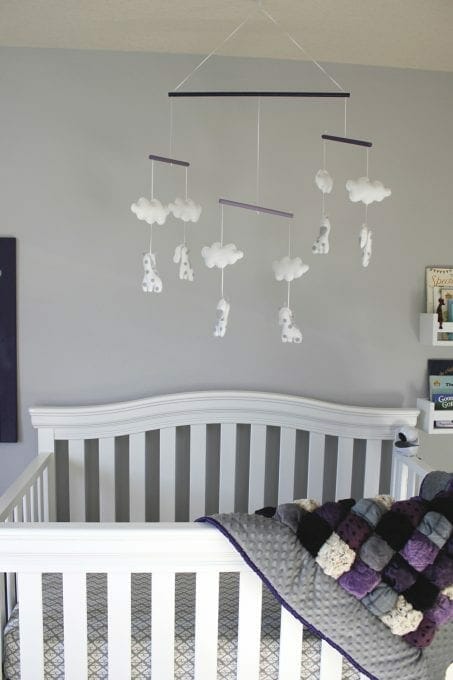 Crib with a mobile overhead image.