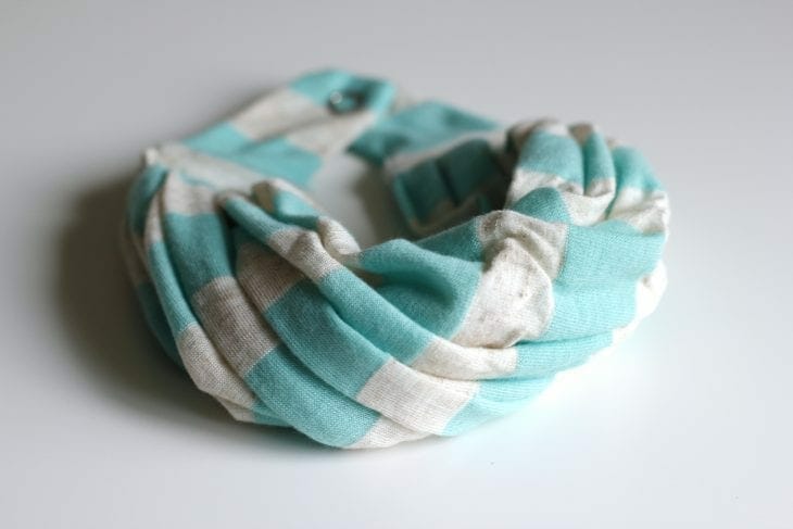 Tiny blue and white infinity scarf made for a baby image.
