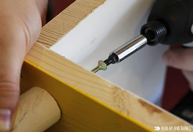 Power drill putting screw into wood image.