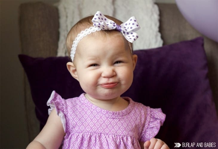 Toddler girl in purple dress smiling image.