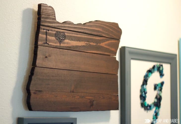 Rustic wooden wall art in the shape of a state image.