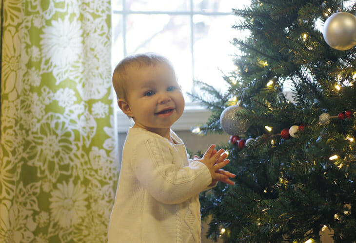 Happy Baby seeing the silver  and purple Christmas tree image.
