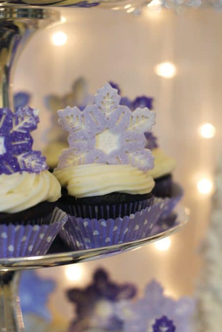 Cupackes with purple snowflake toppers. 