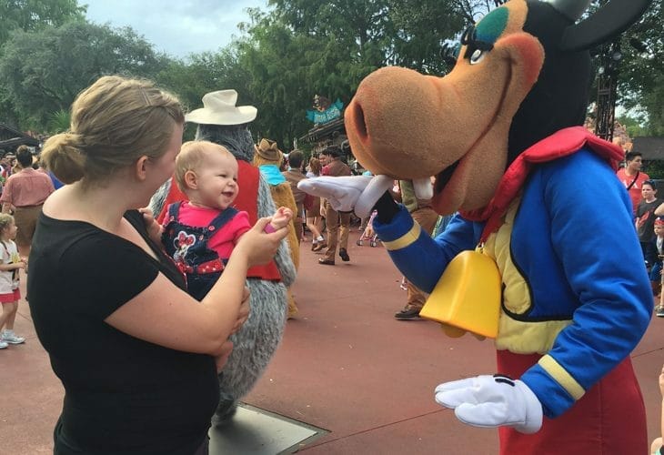Mom and baby meeting a Disney character image.