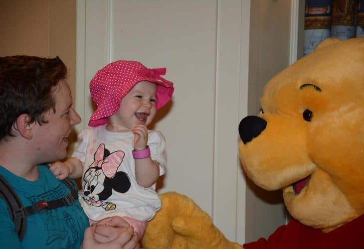 Dad, little girl and Winnie the Pooh image.