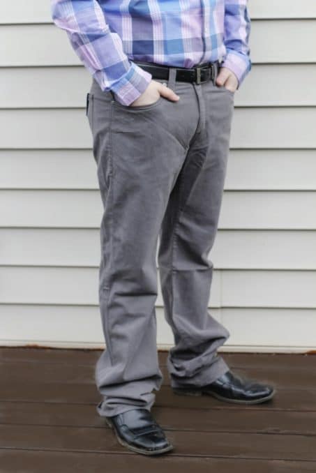 Man wearing gray pants with hands in pocket image.