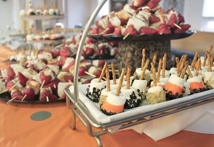 Check this out for many creative college graduation party ideas full of DIY projects and graduation party dessert ideas. Make these simply marshmallow skewers using your school colors and fun different toppings!