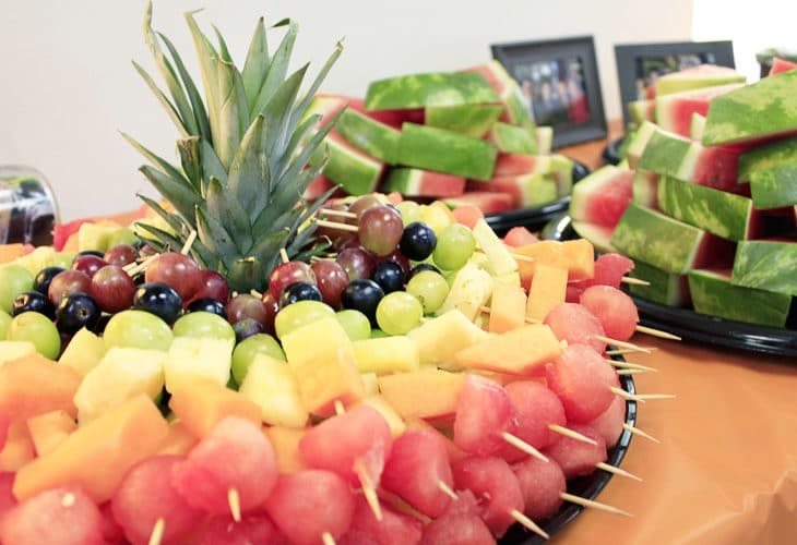 Check this out for many creative college graduation party ideas full of DIY projects and graduation party dessert ideas. Make these rainbow fruit skewers for an easy finger food.