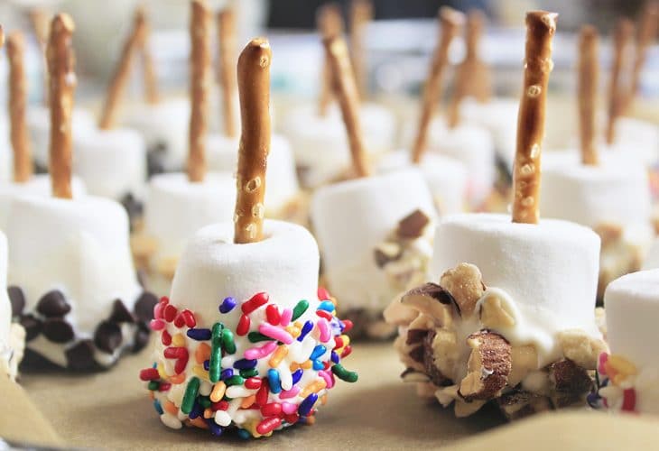 Check this out for many creative college graduation party ideas full of DIY projects and graduation party dessert ideas. So many fun different combinations of marshmallow skewers you can make.