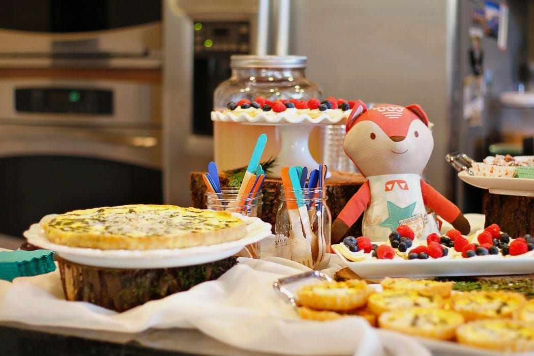 Food buffet with stuffed fox and painted wooden sticks in coordinating colors image. 
