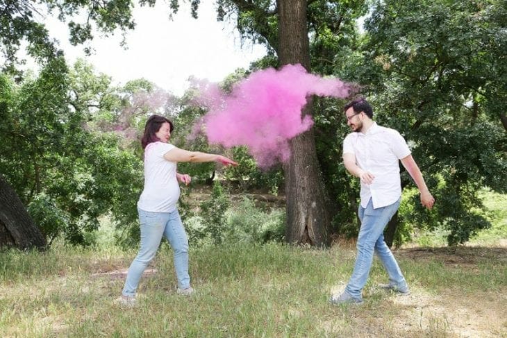 Couple throwingpink holi powder image.