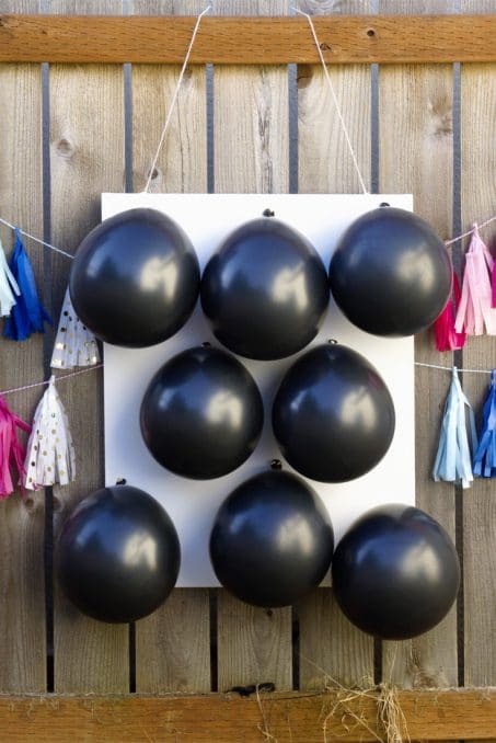 Love this fun and creative gender reveal with balloons and darts. Pin this popular idea!