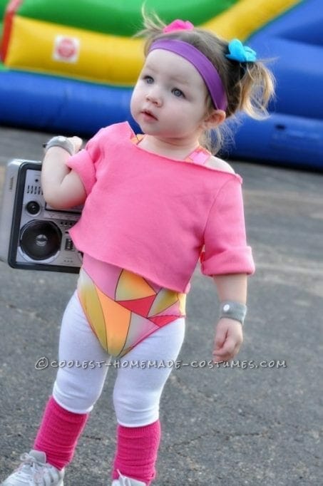 Little girl in 80s workout Halloween costume.