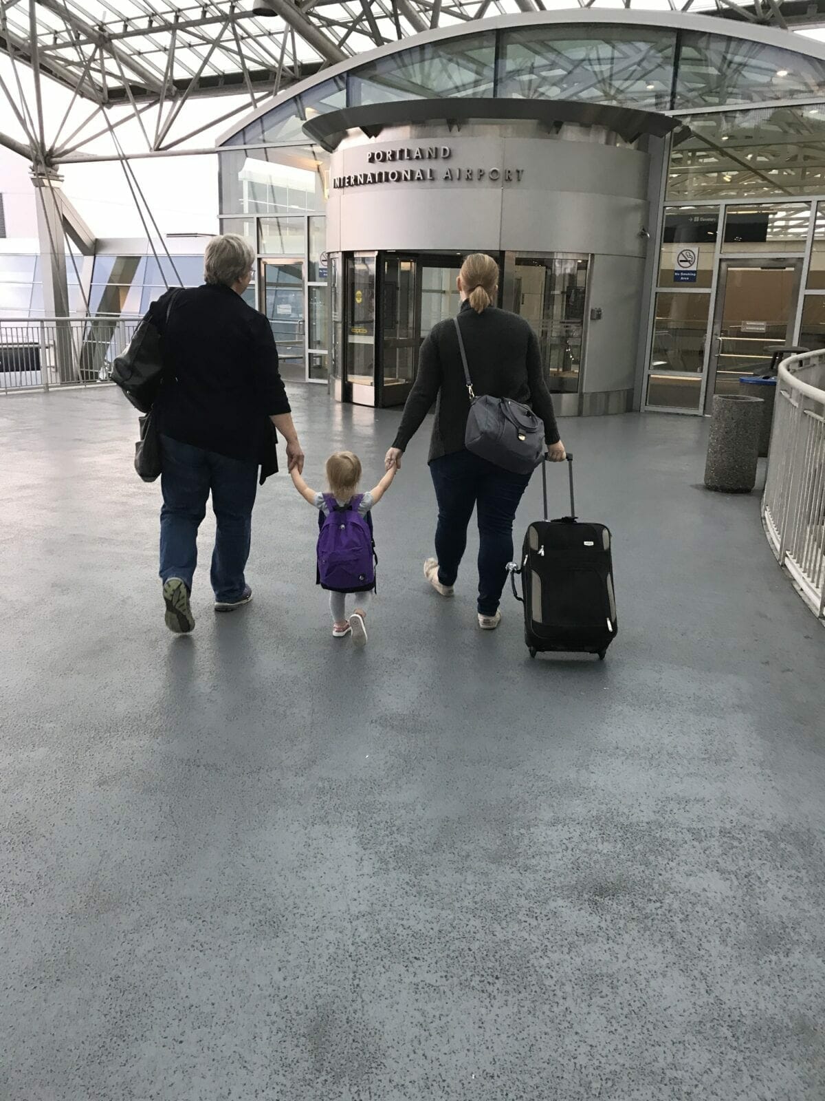 Family walking through airport image.