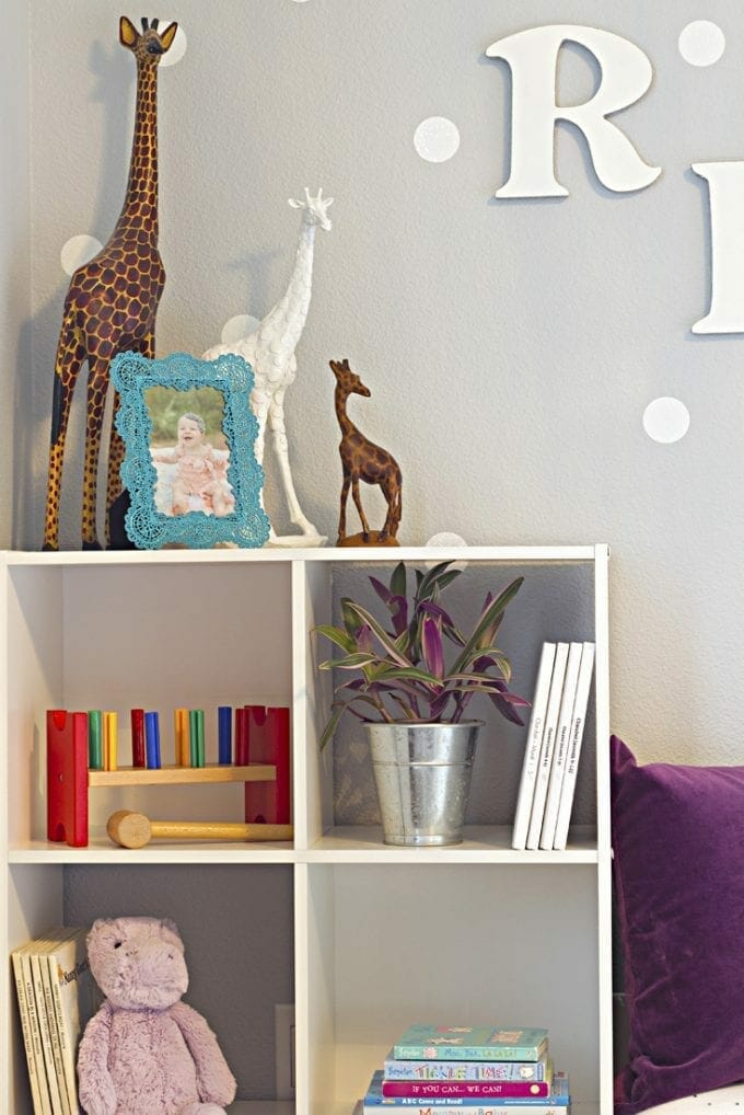 Little girl's bedroom with giraffes on top of a bookcase image.