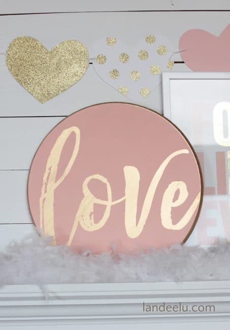 Pink round sign with the world love image.
