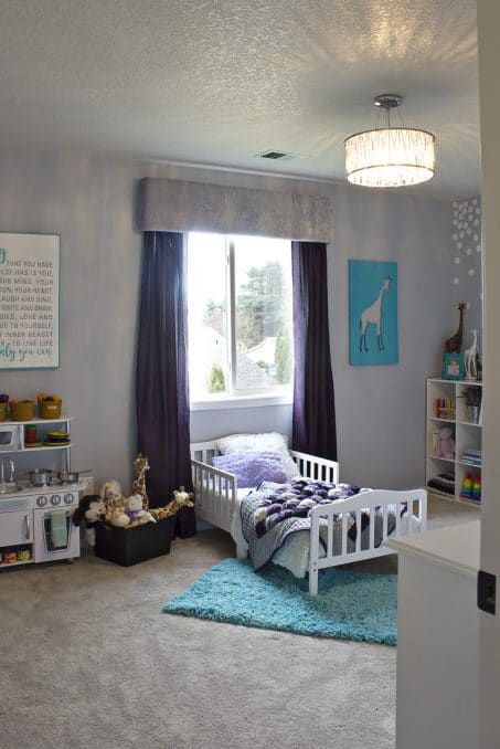 Room featuring a cornice board over a window and a child's bed image.