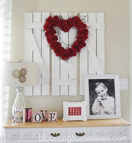 Heart-shaped wreath made of red roses image.