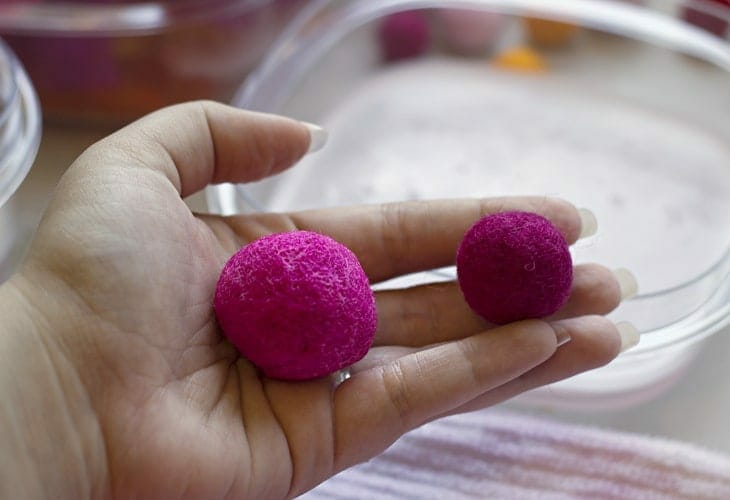  Pink felt balls in hand image.