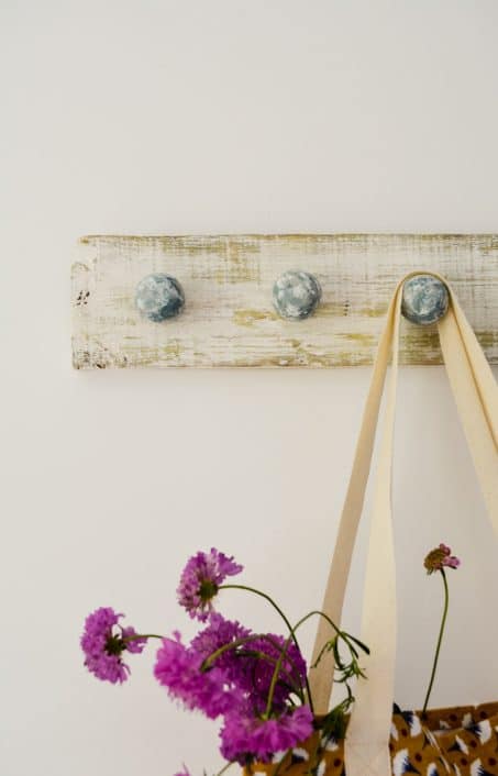 This easy DIY coat hook is perfect for a gorgeous hallway, bathroom, or to arrange necklaces in your bedroom. Check out this farmhouse inspired look!