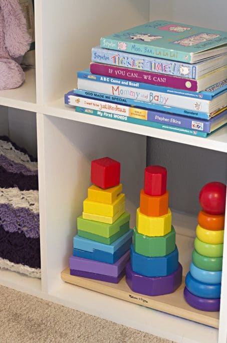Books and toys on child's shelf image.
