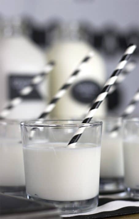 Milk on a table at a black and white birthday party