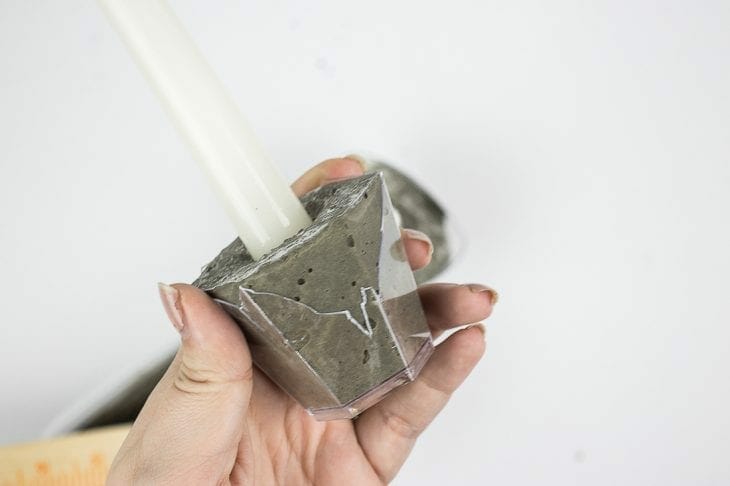 Image of removing plastic cup from cement candle holder