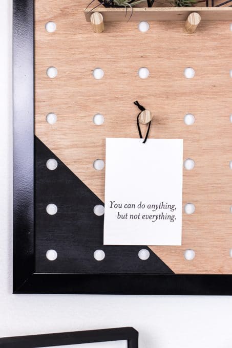 "You can do anything, but not everything" quote hanging on diy giant pegboard image
