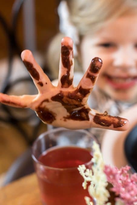 Image of child with chocolate on hand at Valentine's dinner