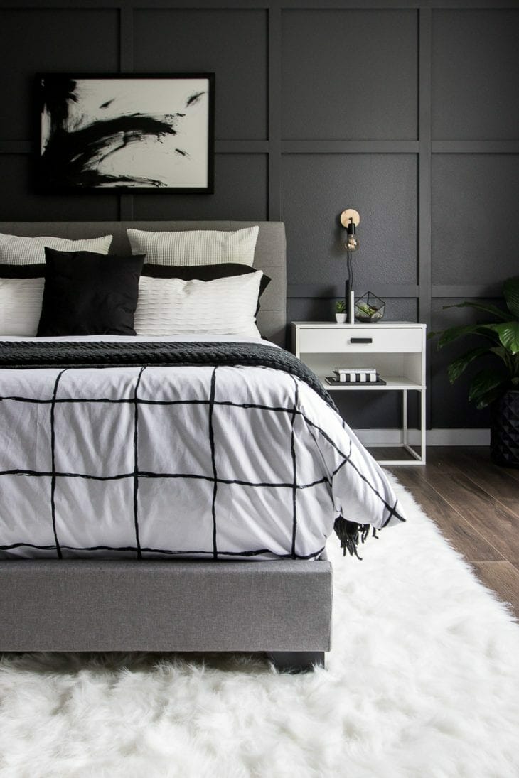 Monochrome modern bed with white faux fur rug image.