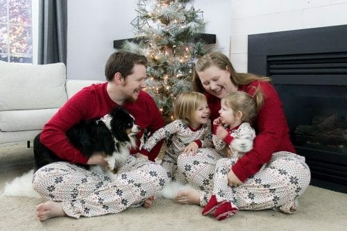Image of happy family in Christmas jammies