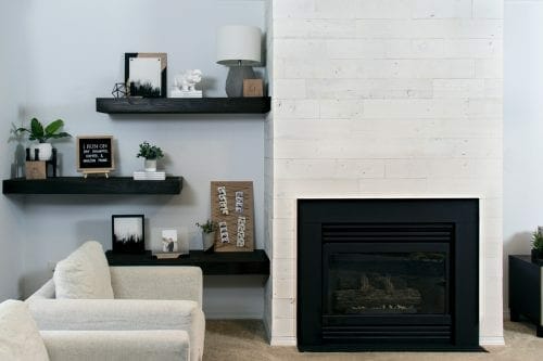 Looking for a quick and easy fireplace update? This modern makeover idea is perfect using peel and stick wood using Stikwood panels and some paint! #fireplacemakeover #stikwood #remodel