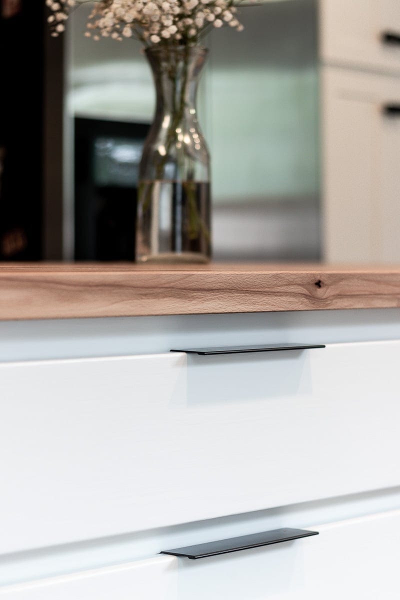 Image of drawer pull in modern white kitchen
