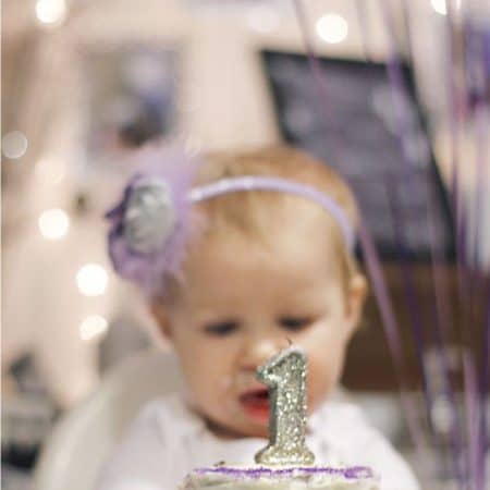 Little girl with 1st birthday cake image.