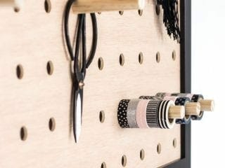 See how to make a DIY giant pegboard perfect to get your office organized. This modern oversized pegboard looks great and is functional. #diy #office #organization