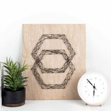 This geometric DIY string art is so easy to make with this simple tutorial and looks great on the wall. Plus, this modern hexagon design is too fun! #diy #homedecor