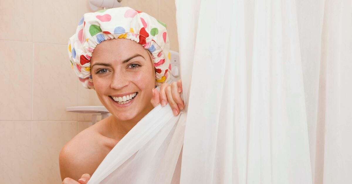 Woman in shower with cap