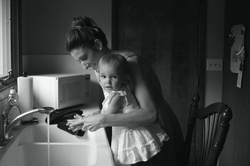 Grayscale Photography of Mother Helping Her Baby to Wash Her Hands