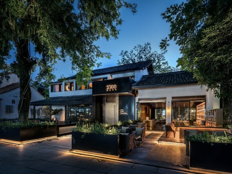 lighted house beside trees