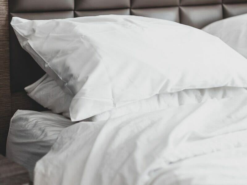 white bed pillow on bed