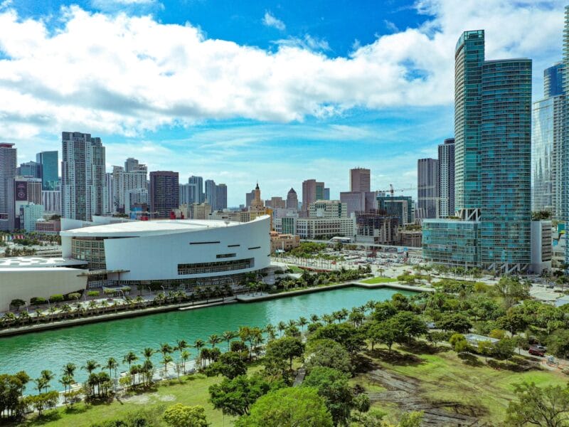 high rise buildings near green trees under blue sky during daytime
