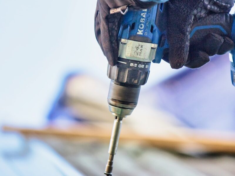 a person using a drill to drill a piece of wood