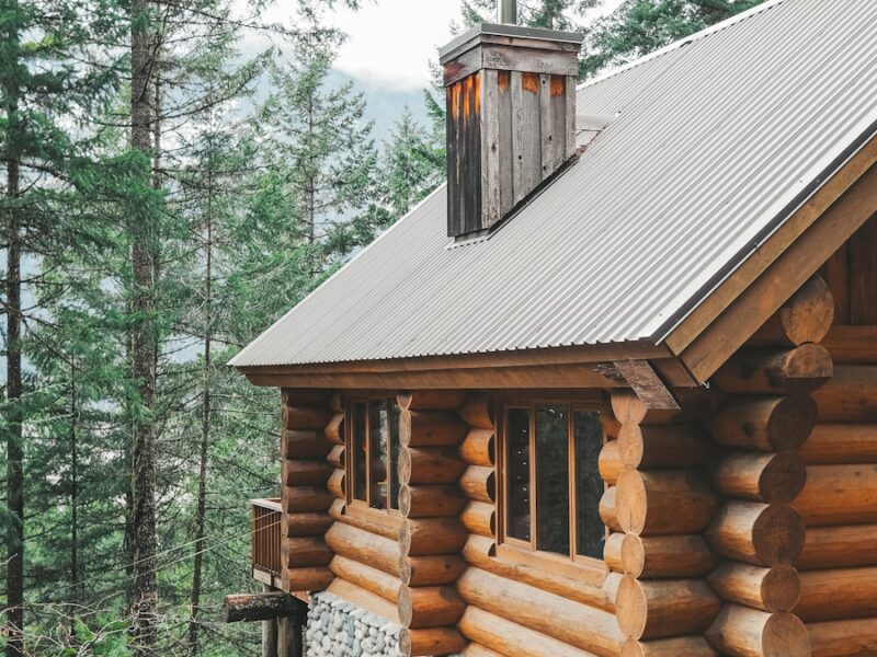 brown wooden house surrounded by green trees during daytime