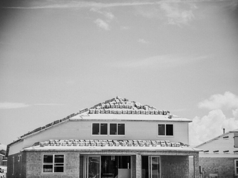 a black and white photo of a house under construction