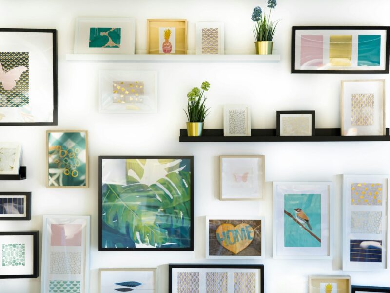assorted-color framed paintings on the wall